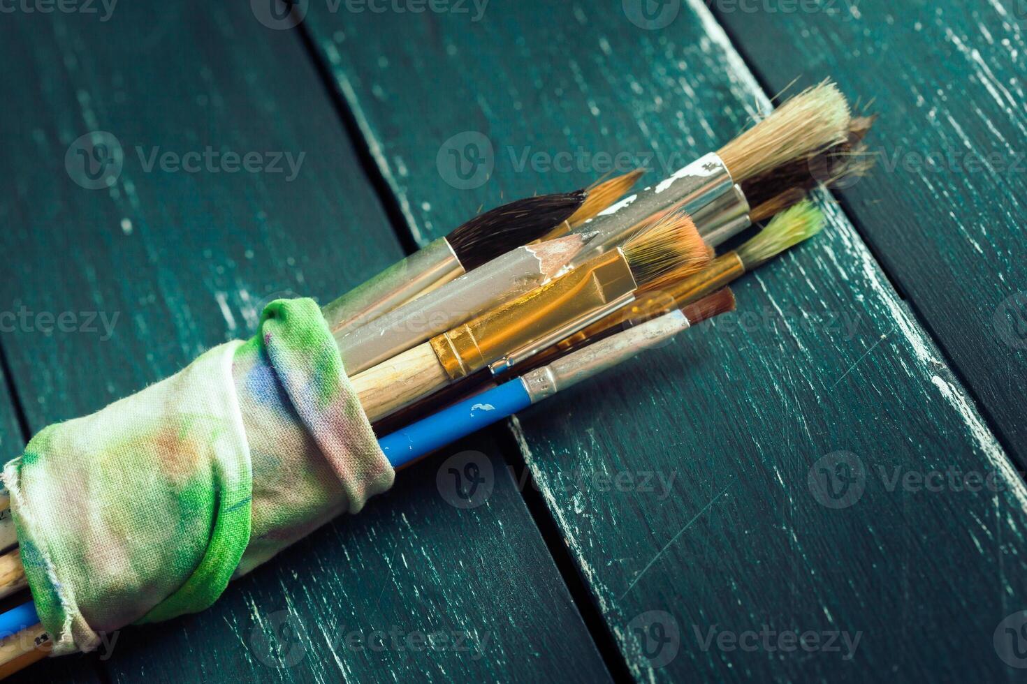 Paint brushes on wooden background photo