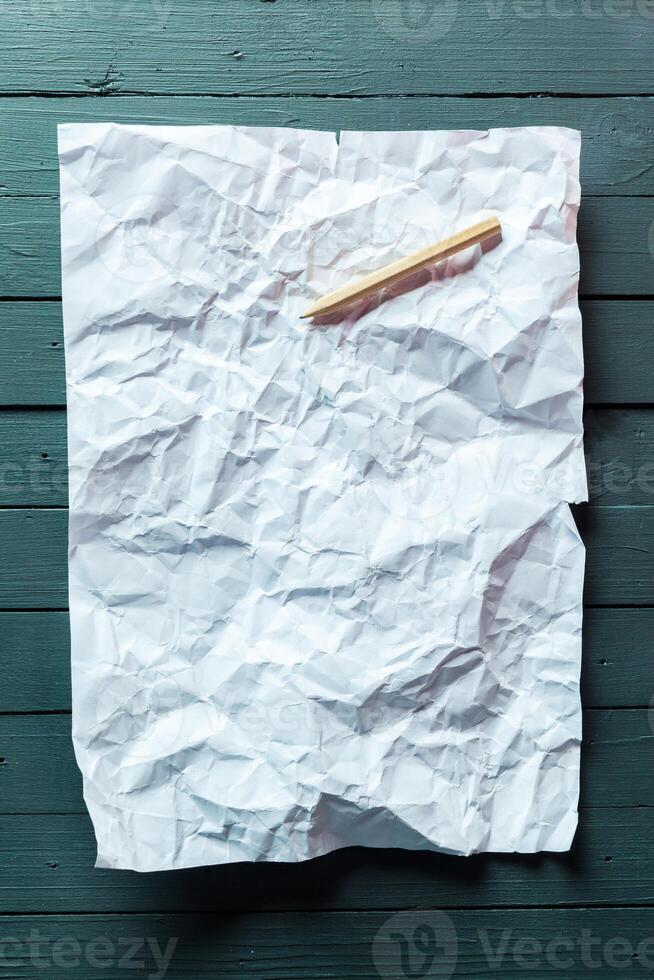 crumpled sheet of paper and pencil photo