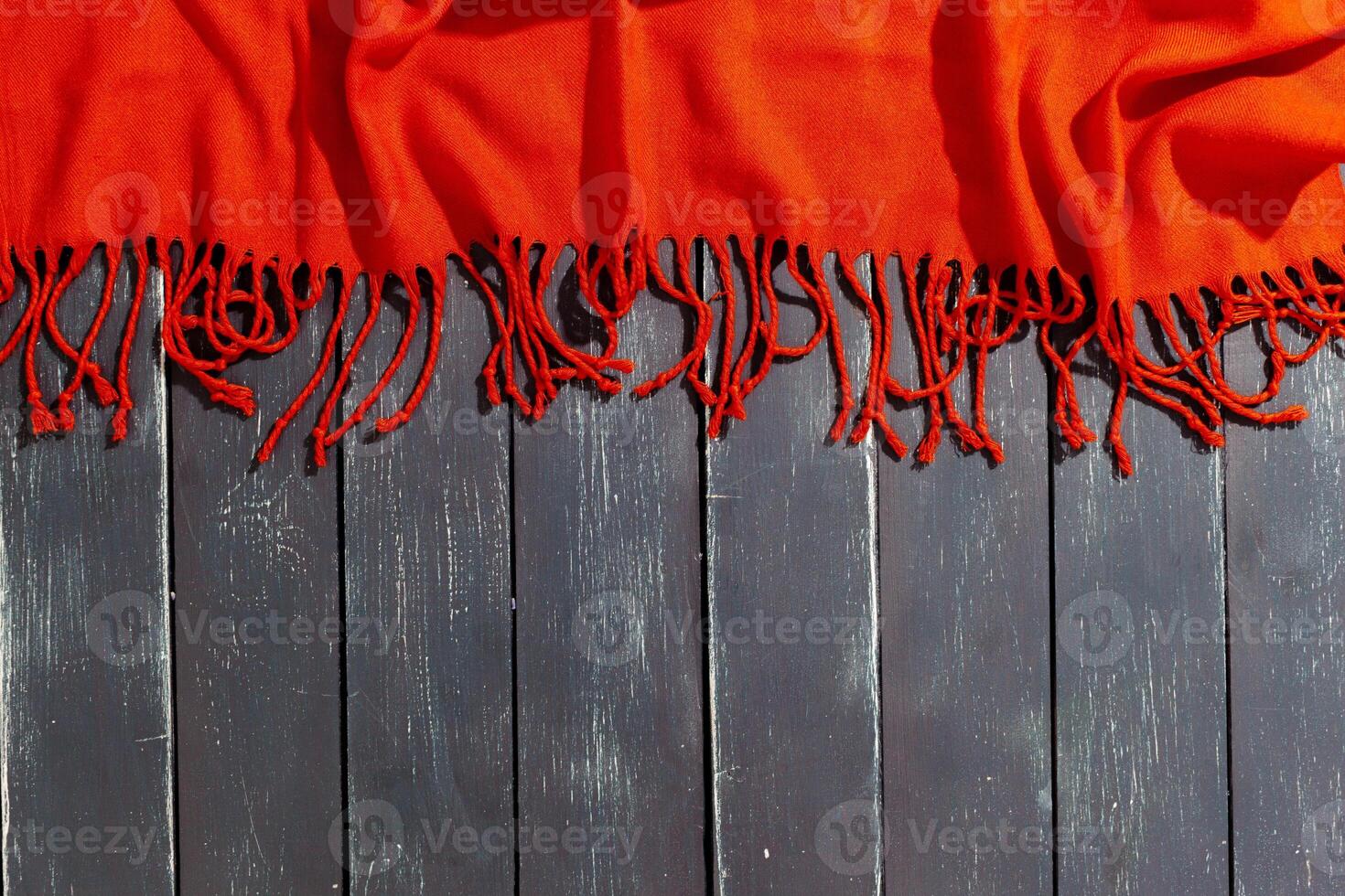 Red scarf over black wood table background photo