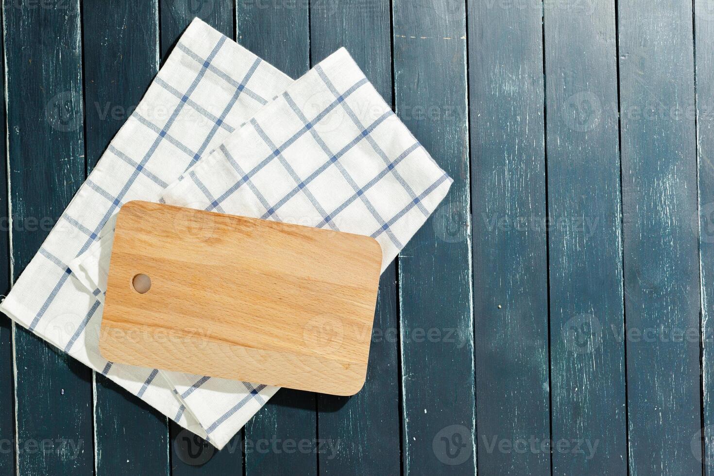 empty wooden board with tablecloth on dark desk photo