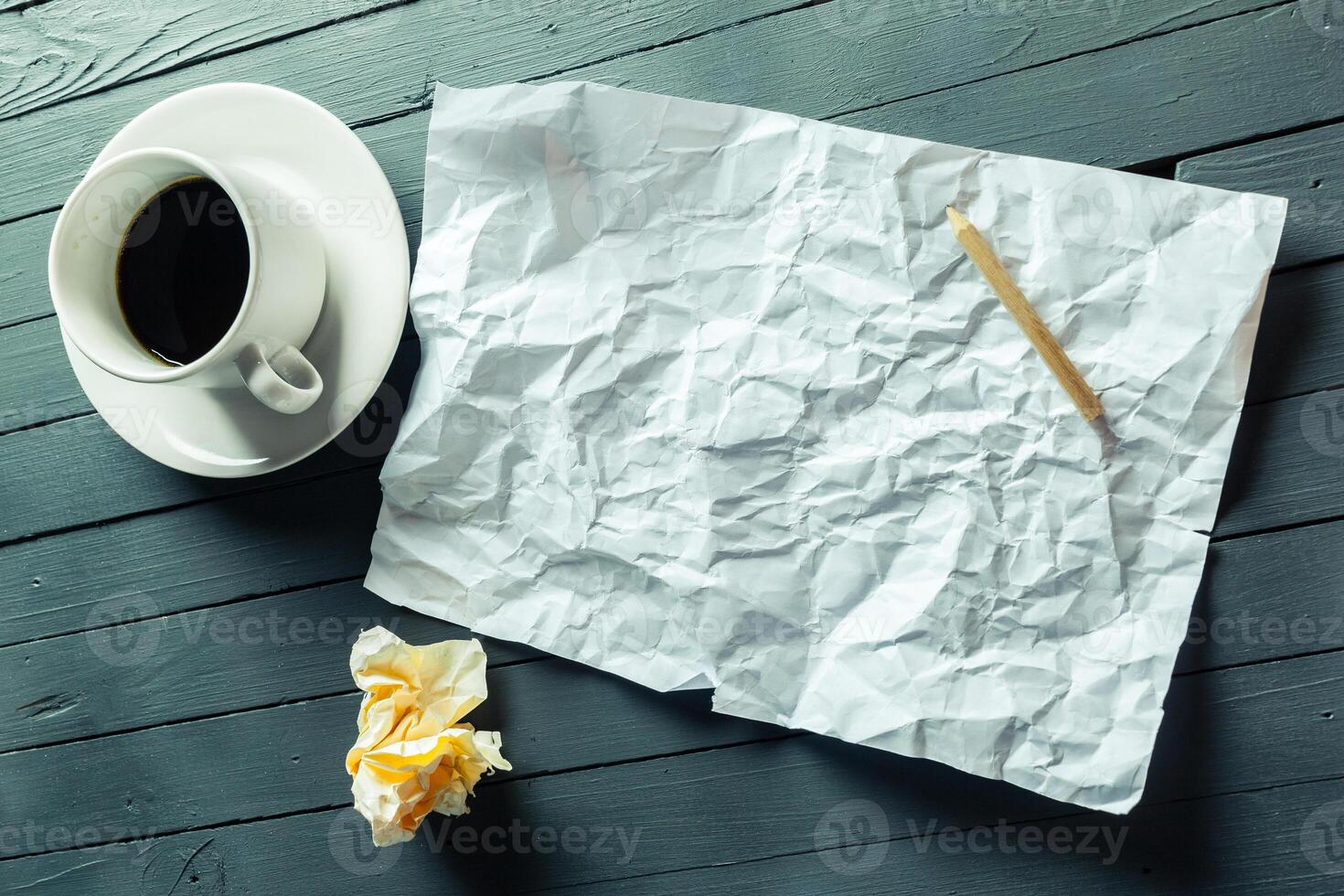 crumpled sheet of paper and pencil photo