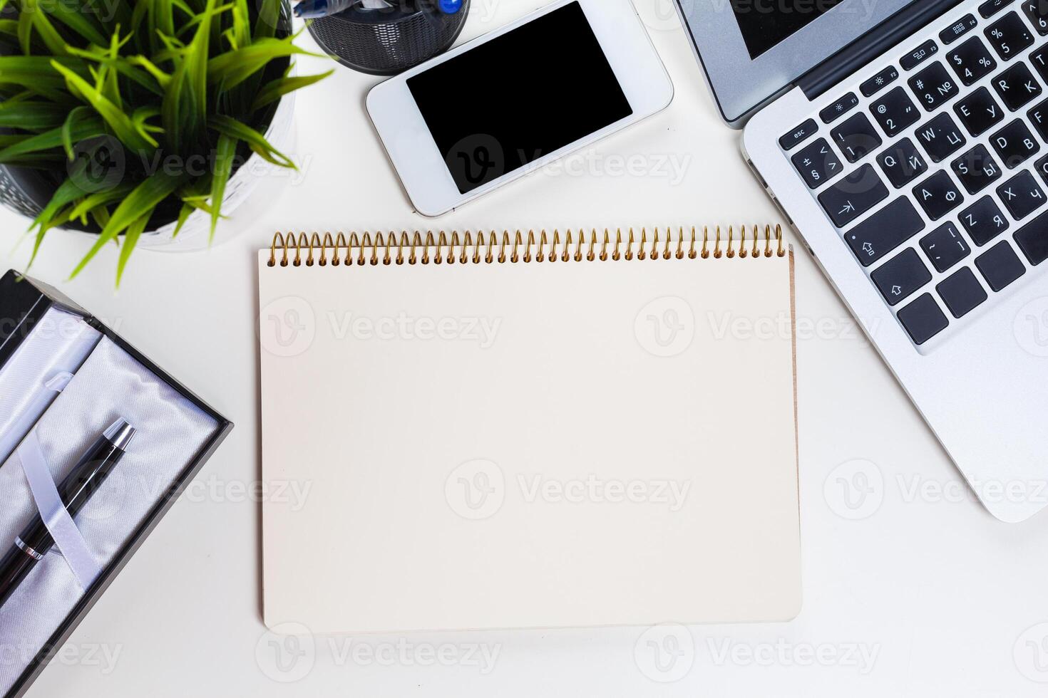 White office desk table with a lot of things on it. Top view photo