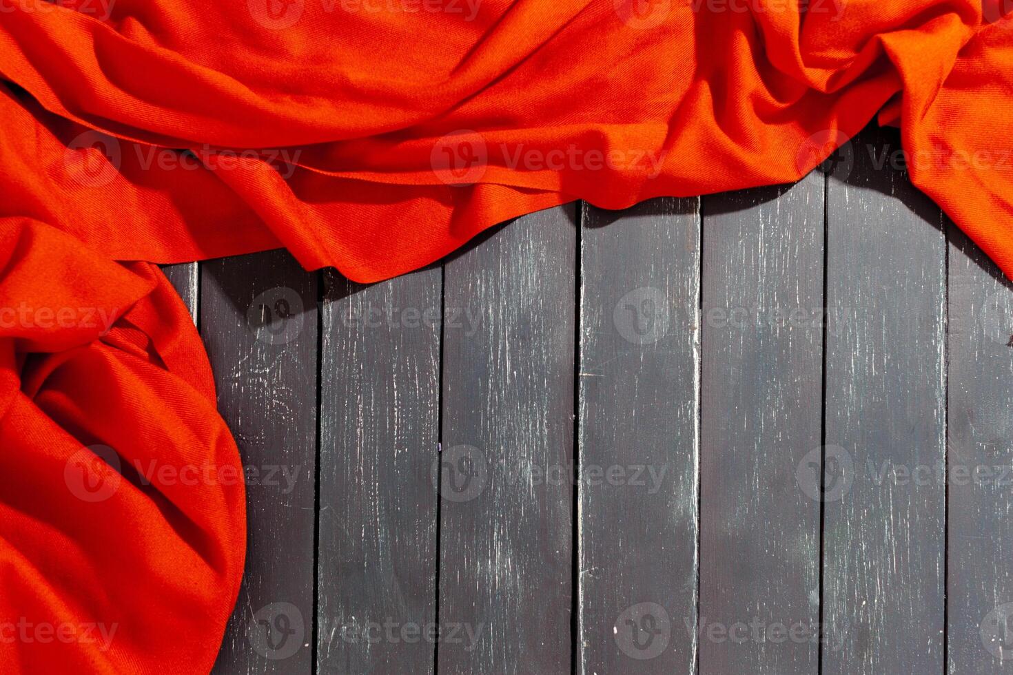 Red scarf over black wood table background photo