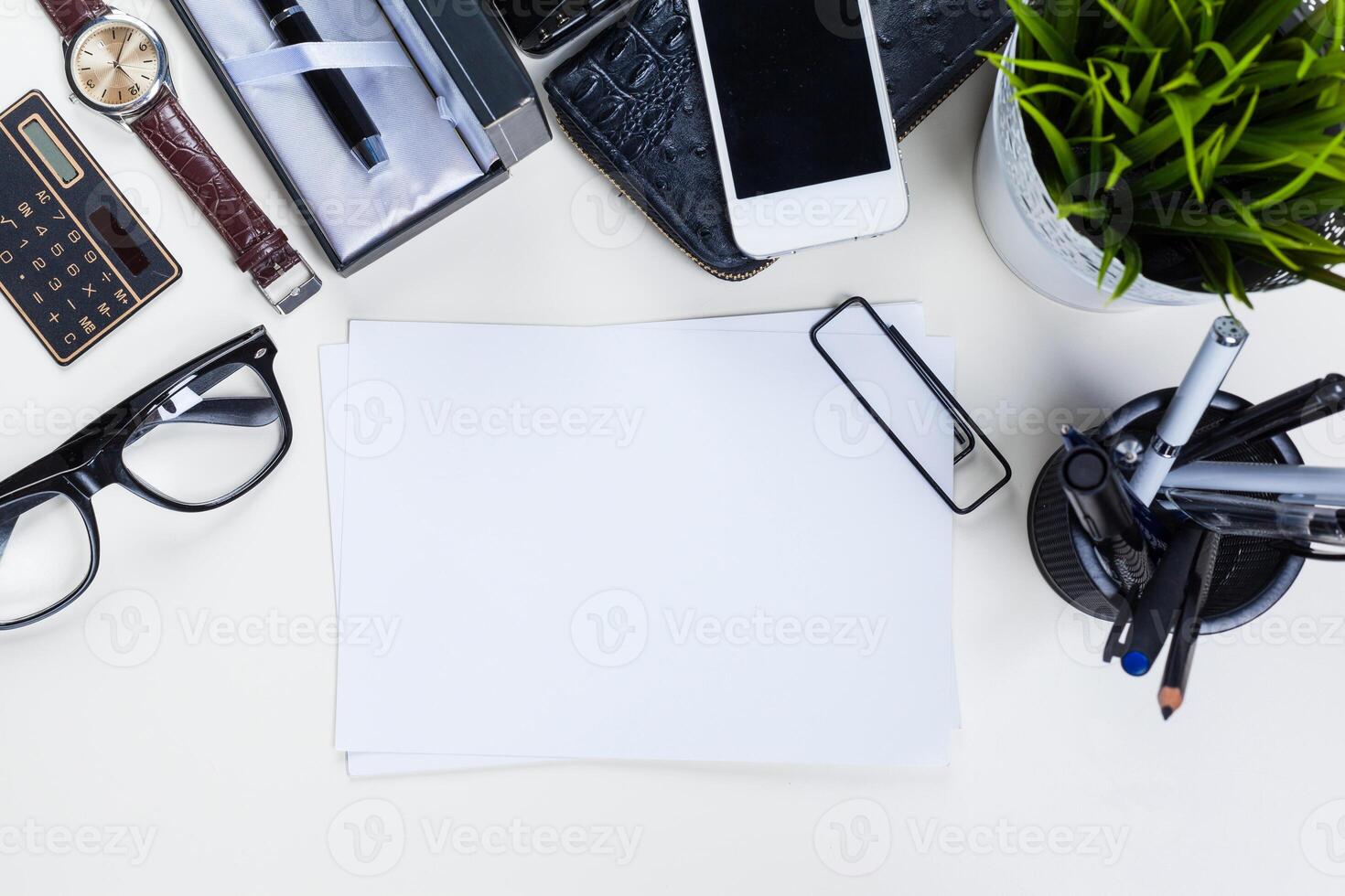 White office desk table with a lot of things on it. Top view photo