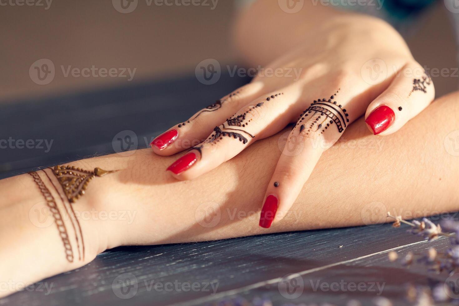 Process of applying mehndi on female hands photo