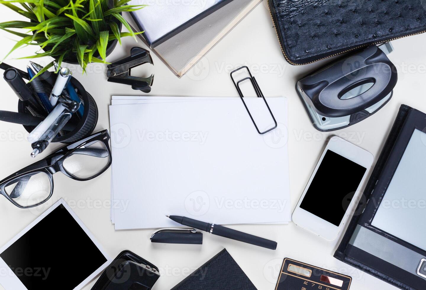White office desk table with a lot of things on it. Top view photo