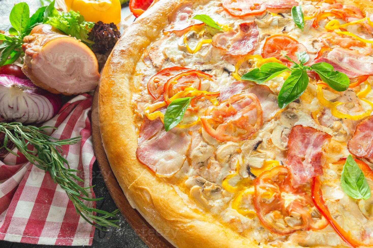 Pizza with dry cured ham and basil photo