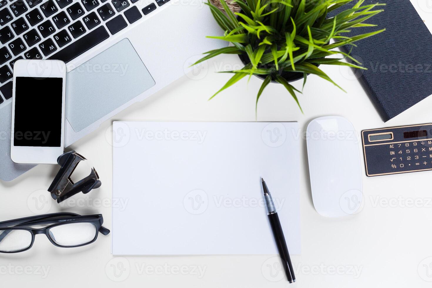 White office desk table with a lot of things on it. Top view photo