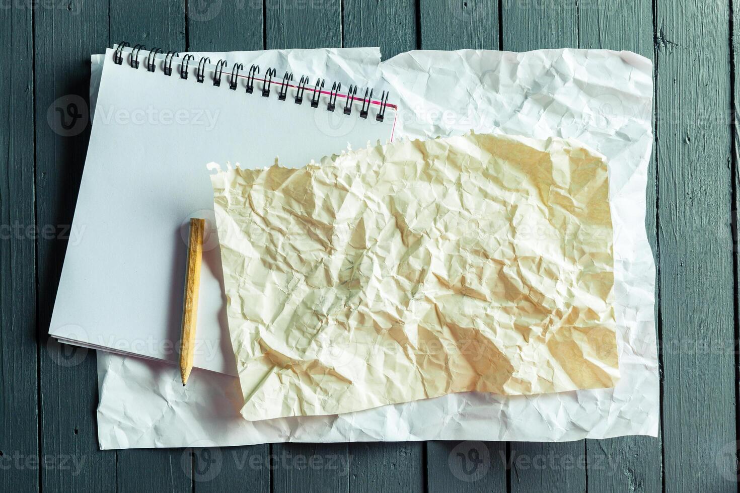 crumpled sheet of paper and pencil photo