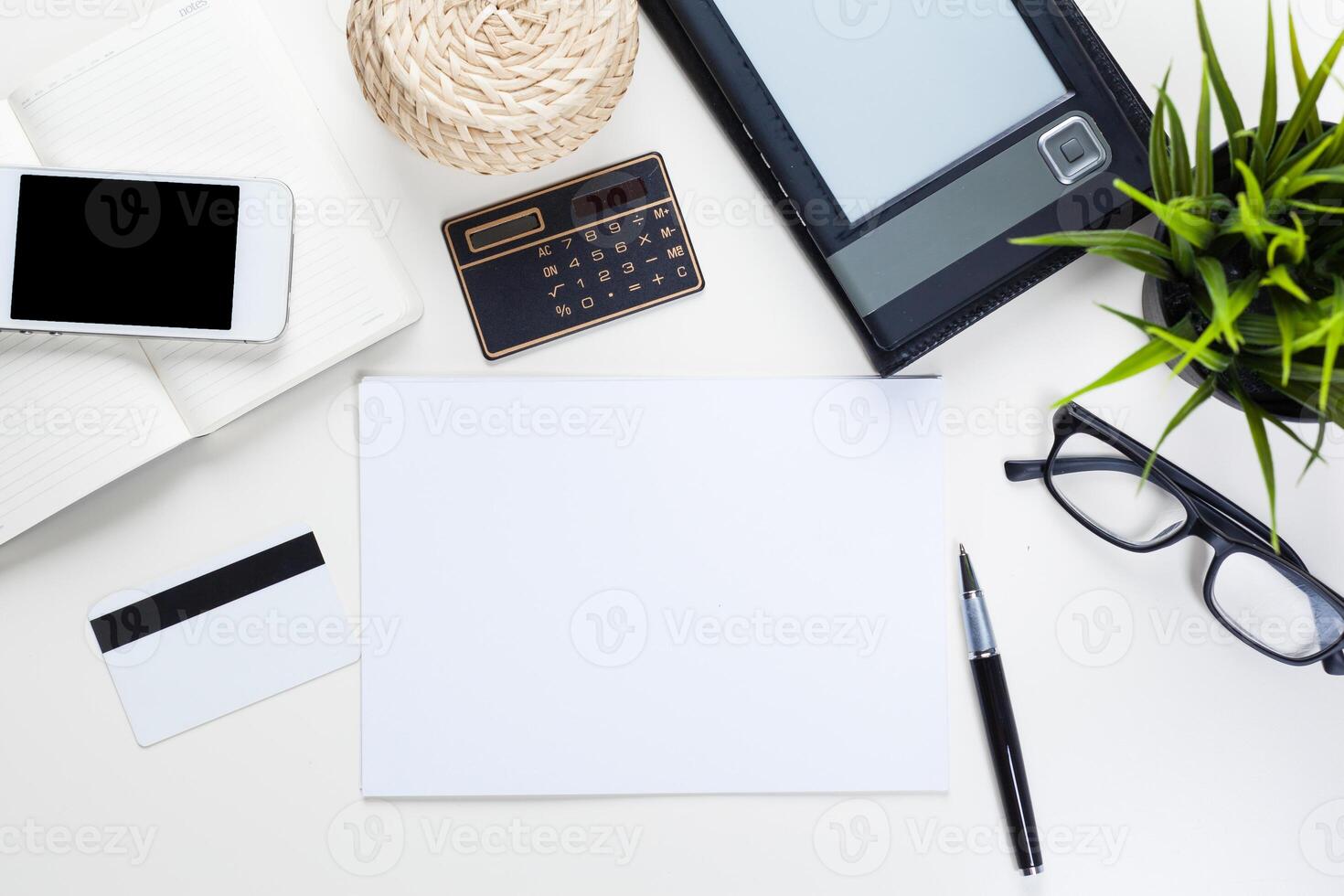 White office desk table with a lot of things on it. Top view photo