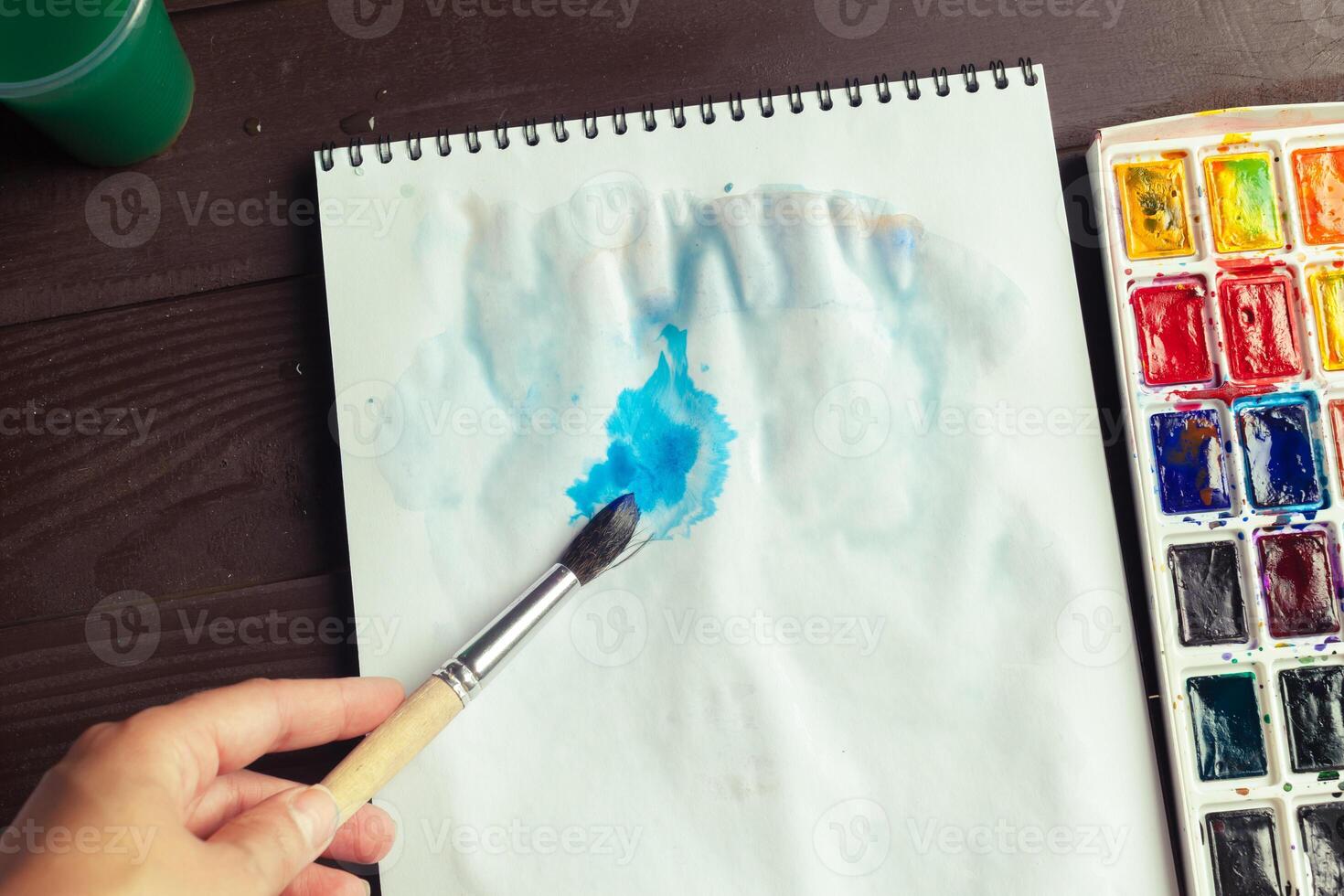 Set of watercolor paints and paintbrushes for painting photo
