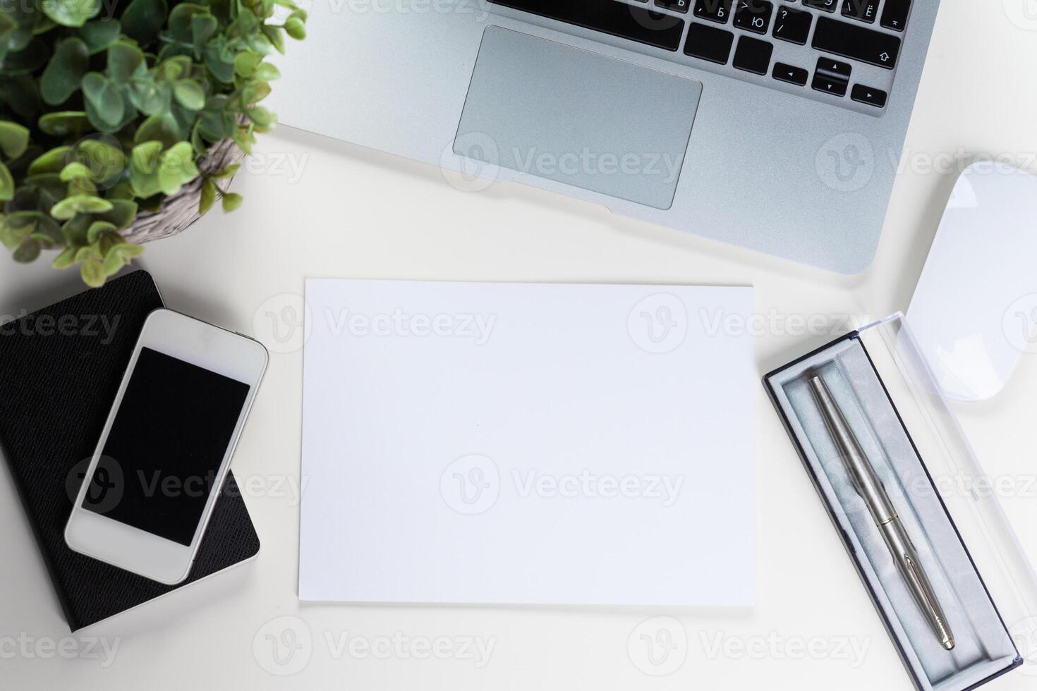 White office desk table with a lot of things on it. Top view photo