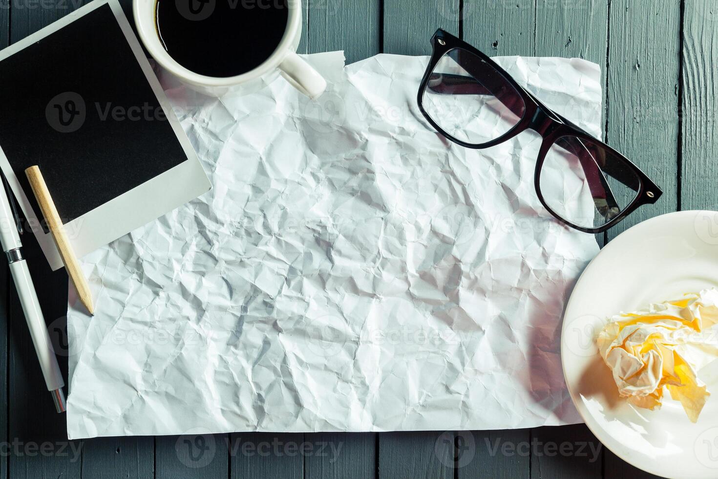 crumpled sheet of paper and pencil photo