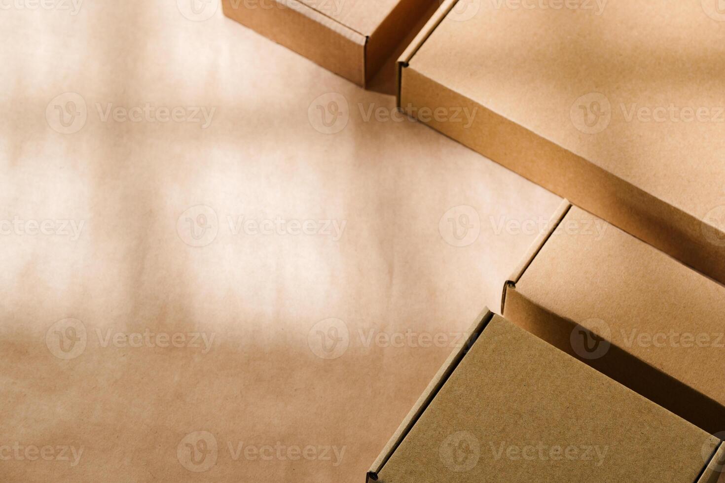 Brown cardboard boxes arranged on a neutral background in a warehouse setting during daylight hours photo
