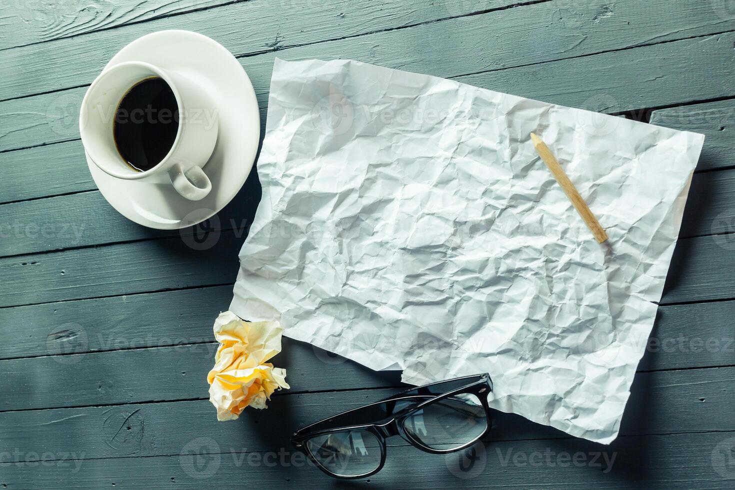 crumpled sheet of paper and pencil photo