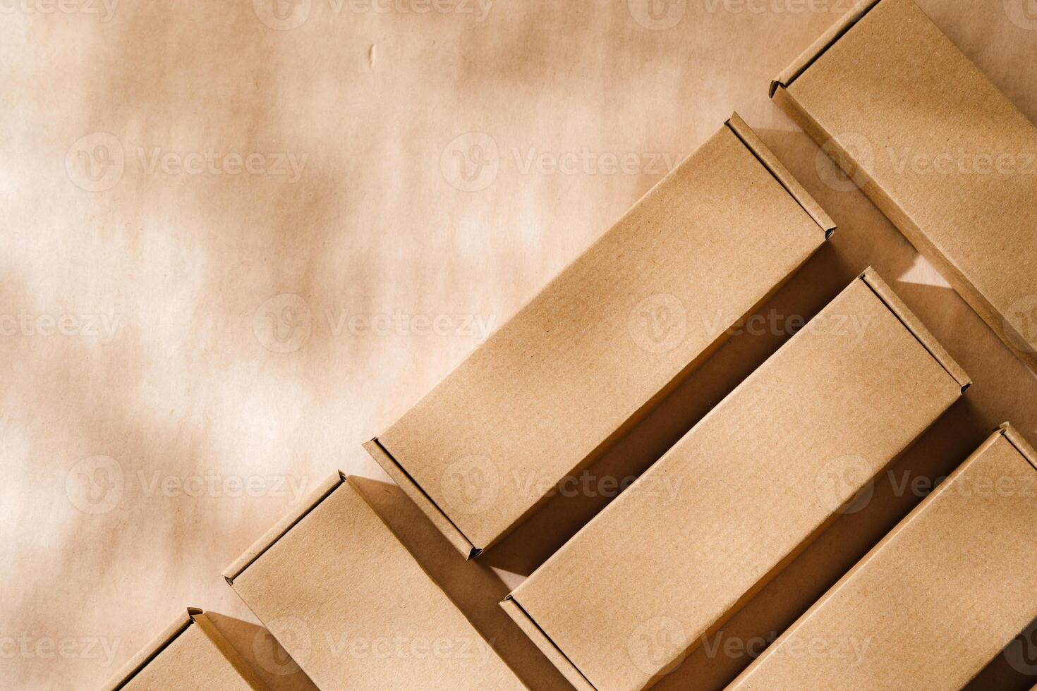 Brown cardboard boxes arranged on a neutral background in a warehouse setting during daylight hours photo