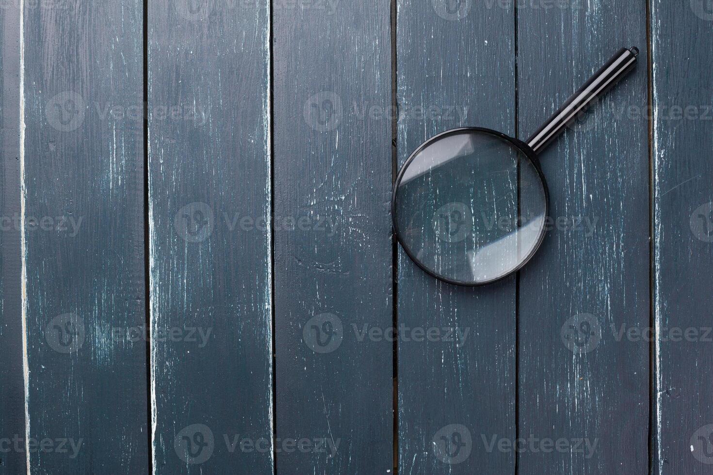 magnifying glass or loupe on wooden table photo