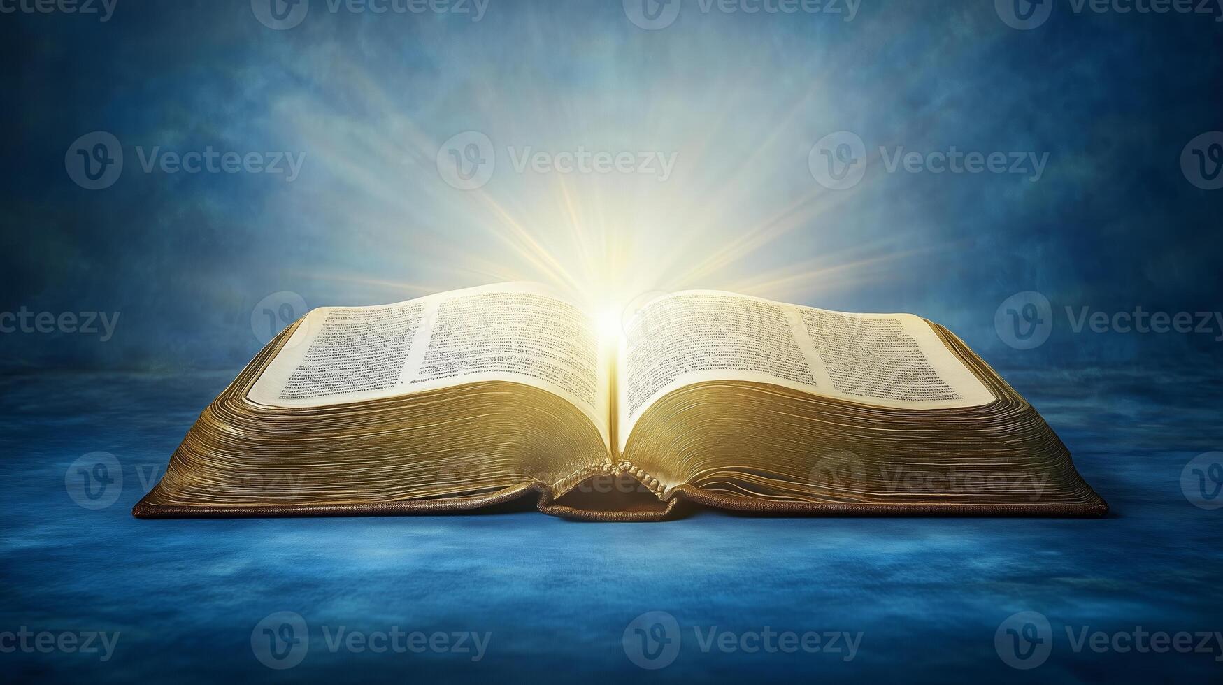 An open book emits a radiant glow against a blue background, symbolizing knowledge and enlightenment in a serene setting photo