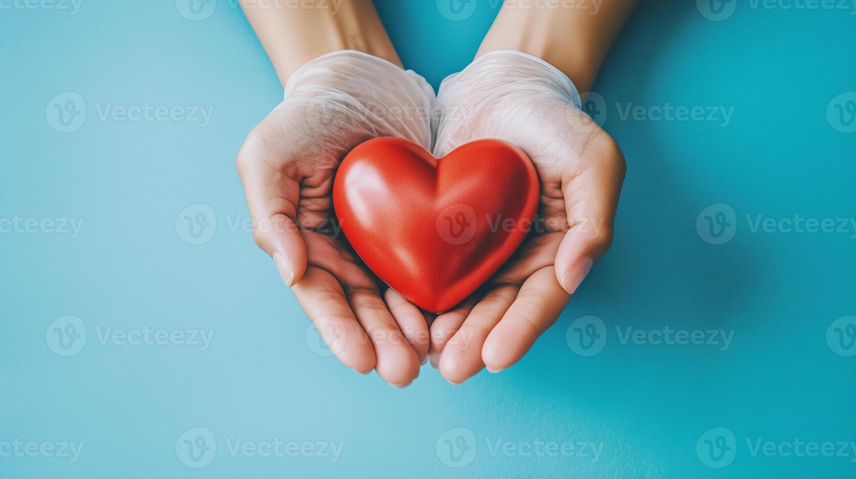 manos vistiendo guantes sostener un vibrante rojo corazón en contra un brillante azul fondo, simbolizando cuidado y compasión foto