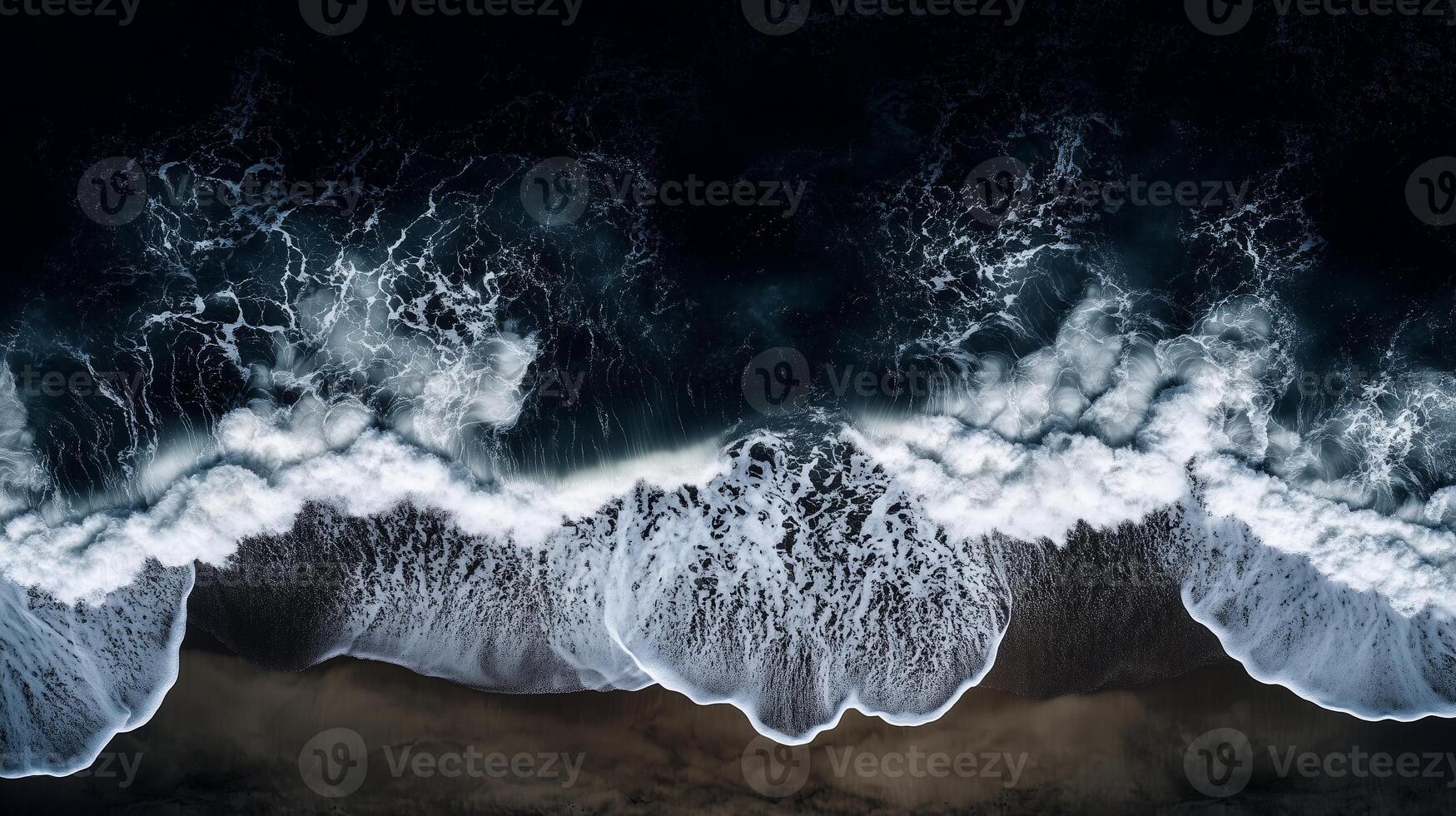 Aerial view of turbulent ocean waves crashing against the shoreline at dusk photo