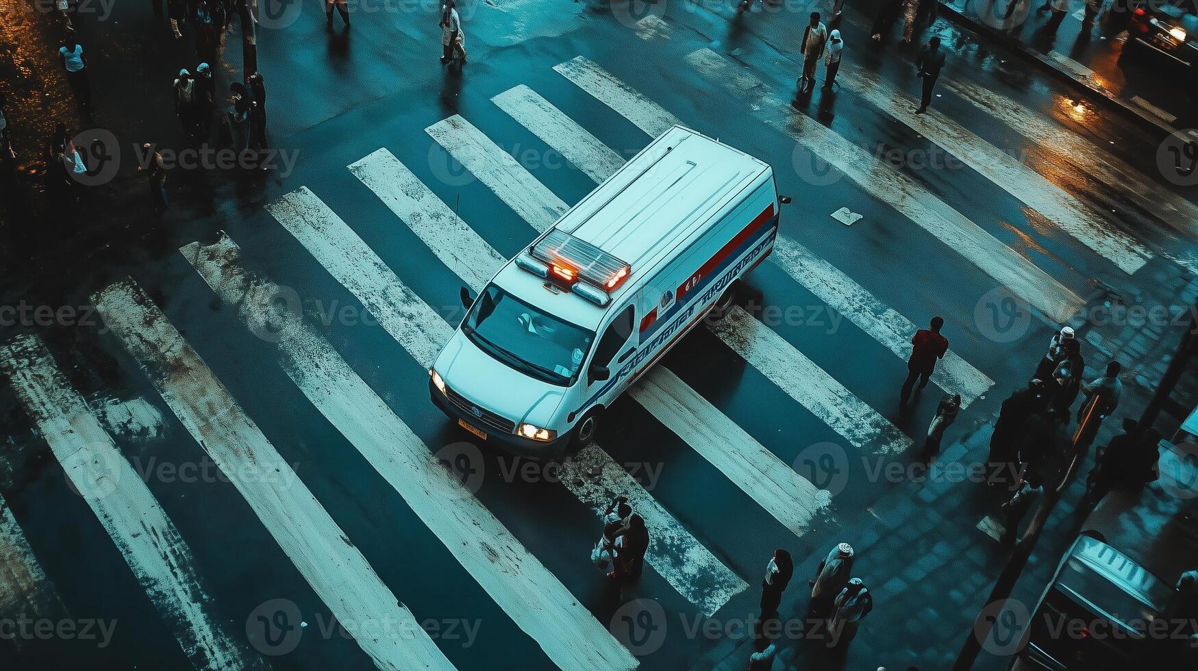 Ambulance navigating a busy crosswalk during a late evening in an urban environment photo