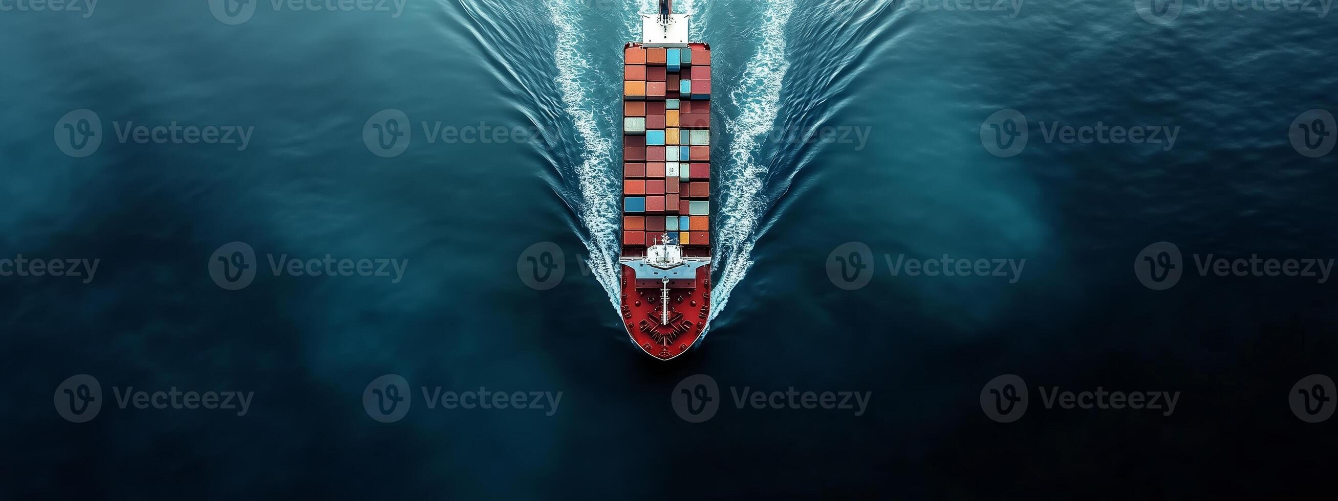 Aerial view of a cargo ship navigating through dark waters with colorful containers during daytime photo