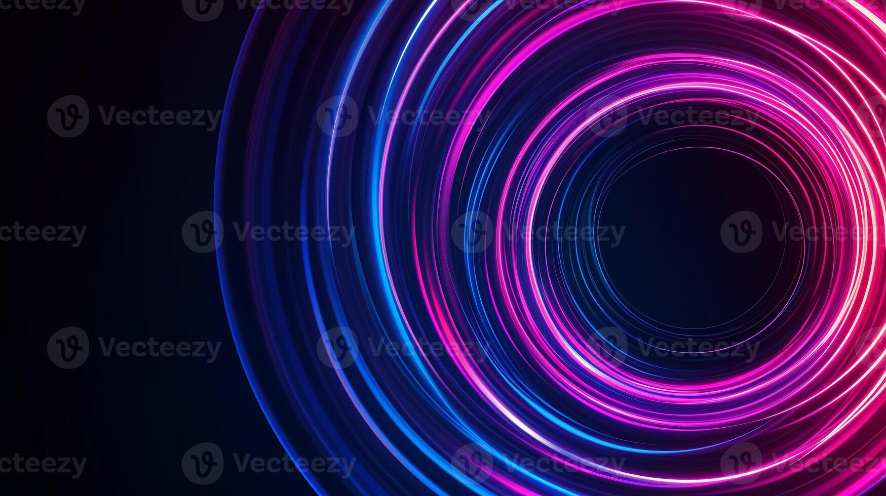 Colorful light trails create dynamic circular patterns in a dark setting, showcasing vibrant hues of pink and blue photo