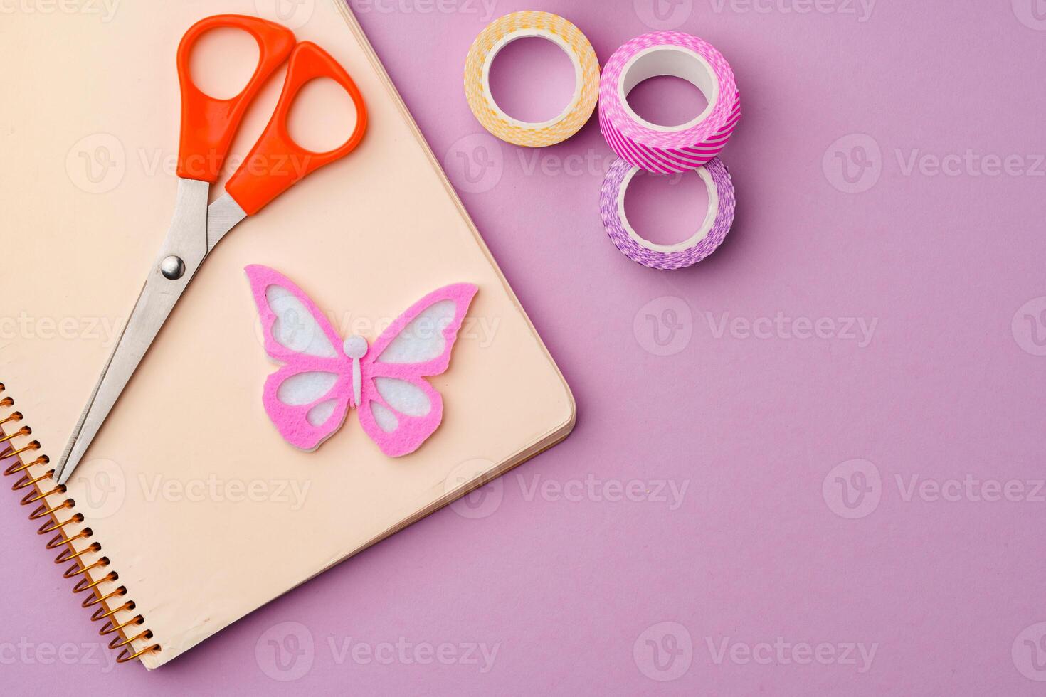 Crafting supplies on a purple background ready for creative projects photo