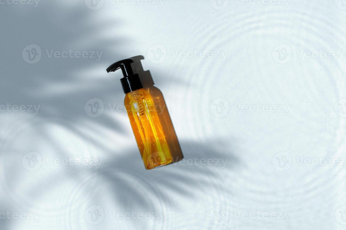 Skincare product bottle positioned against a light background with shadows photo