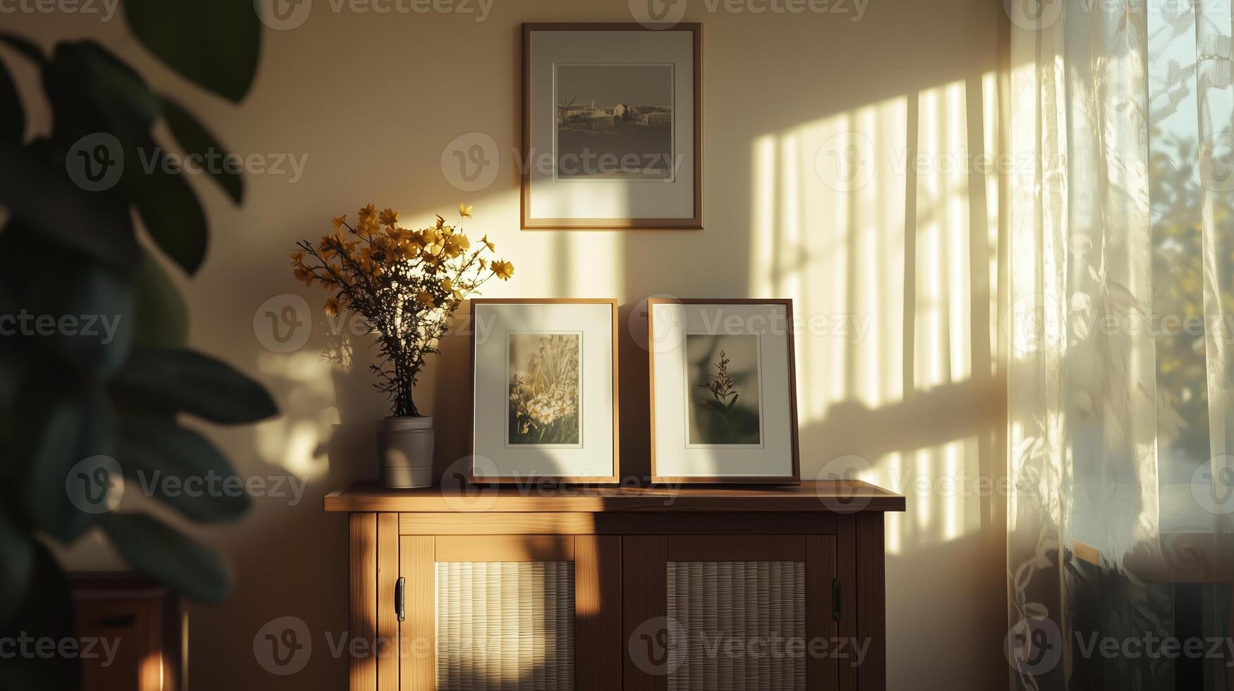 Sunlight streaming through curtains in a cozy room with framed artwork and a flower vase on a wooden sideboard photo