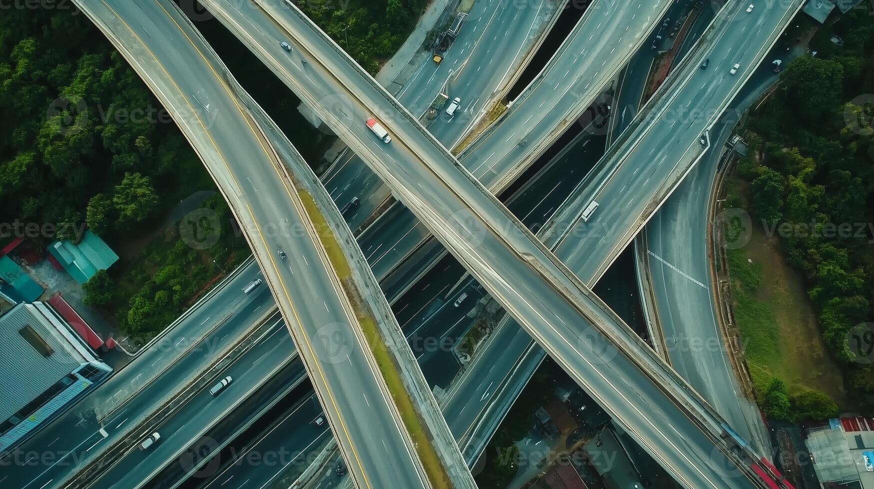 Aerial view of a complex highway interchange surrounded by greenery in a bustling urban area during daylight photo