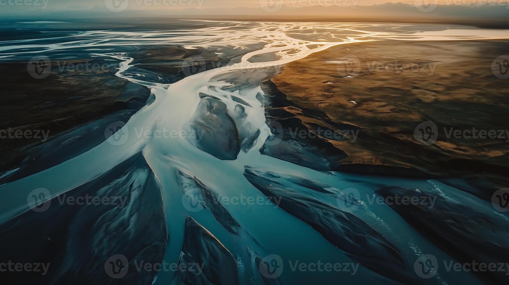 Aerial view of winding rivers flowing through a vast landscape at sunset, highlighting the intricate patterns of nature in this serene location photo