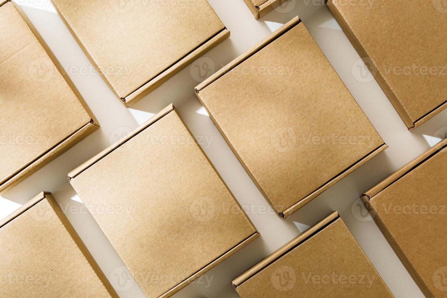 Brown cardboard boxes arranged on a neutral background in a warehouse setting during daylight hours photo