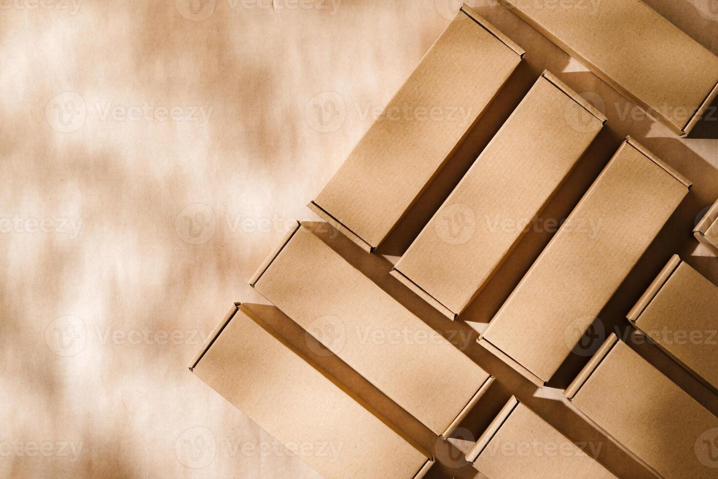 Brown cardboard boxes arranged on a neutral background in a warehouse setting during daylight hours photo