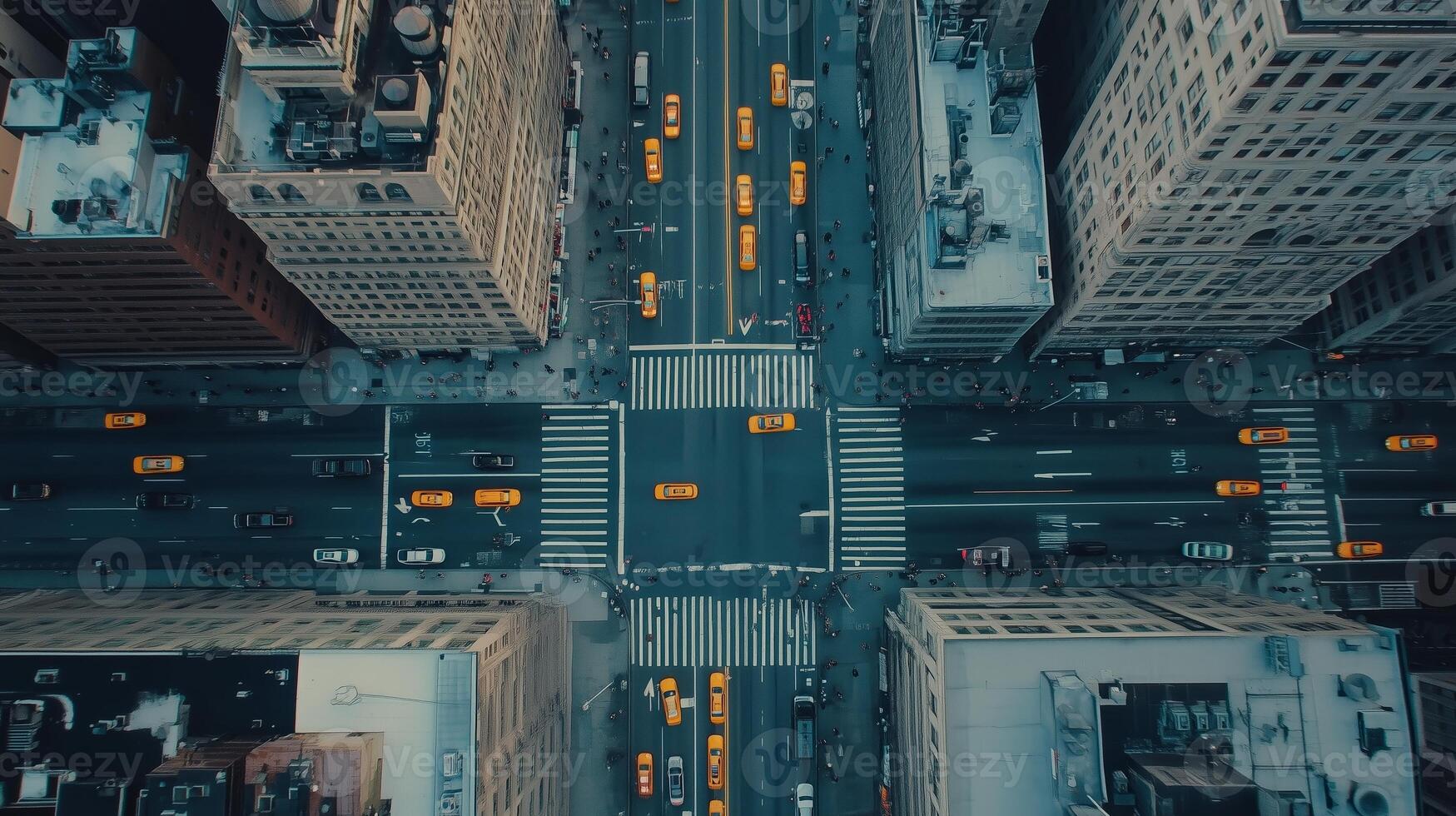 Aerial view of a bustling city intersection with yellow taxis in motion during rush hour photo