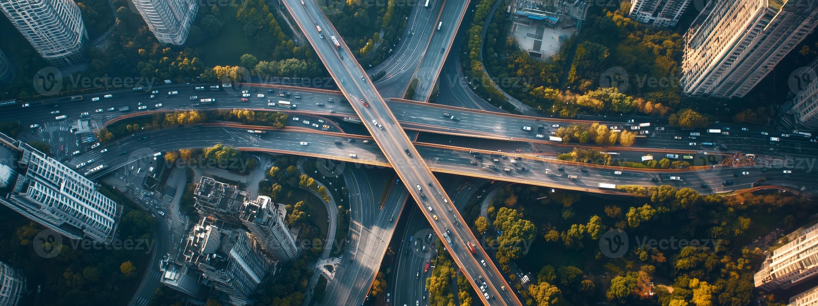 Aerial view of a busy highway interchange surrounded by urban buildings and greenery during daylight photo