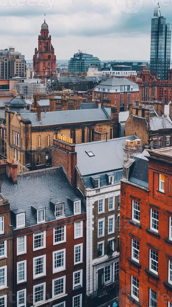 Aerial view of Manchester's historic architecture blending with modern skyscrapers under a cloudy sky photo