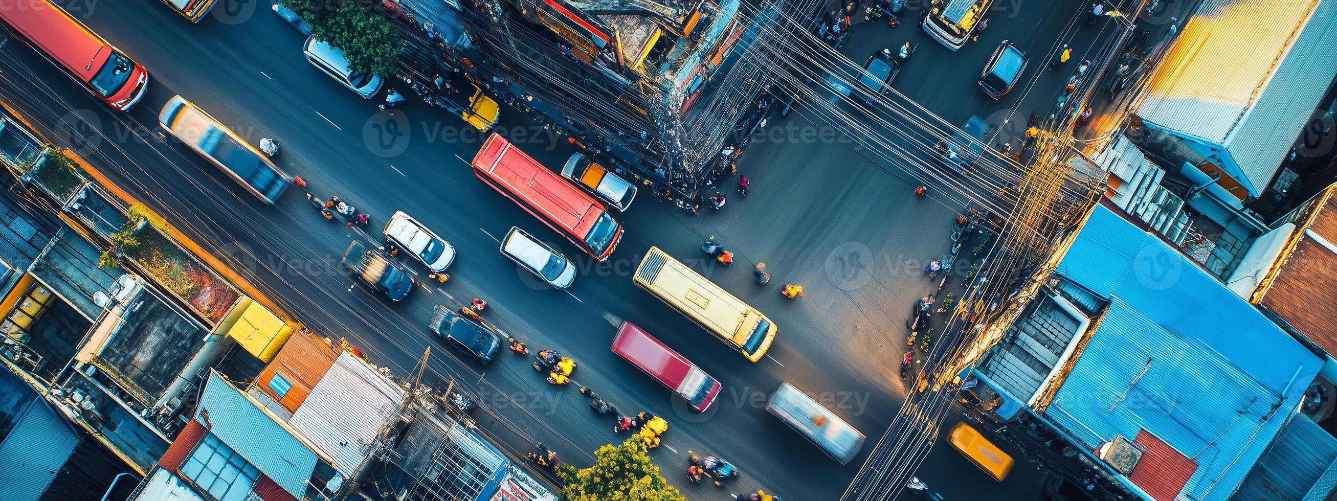 Aerial view of a bustling urban intersection in the city during midday with vehicles and pedestrians navigating traffic photo