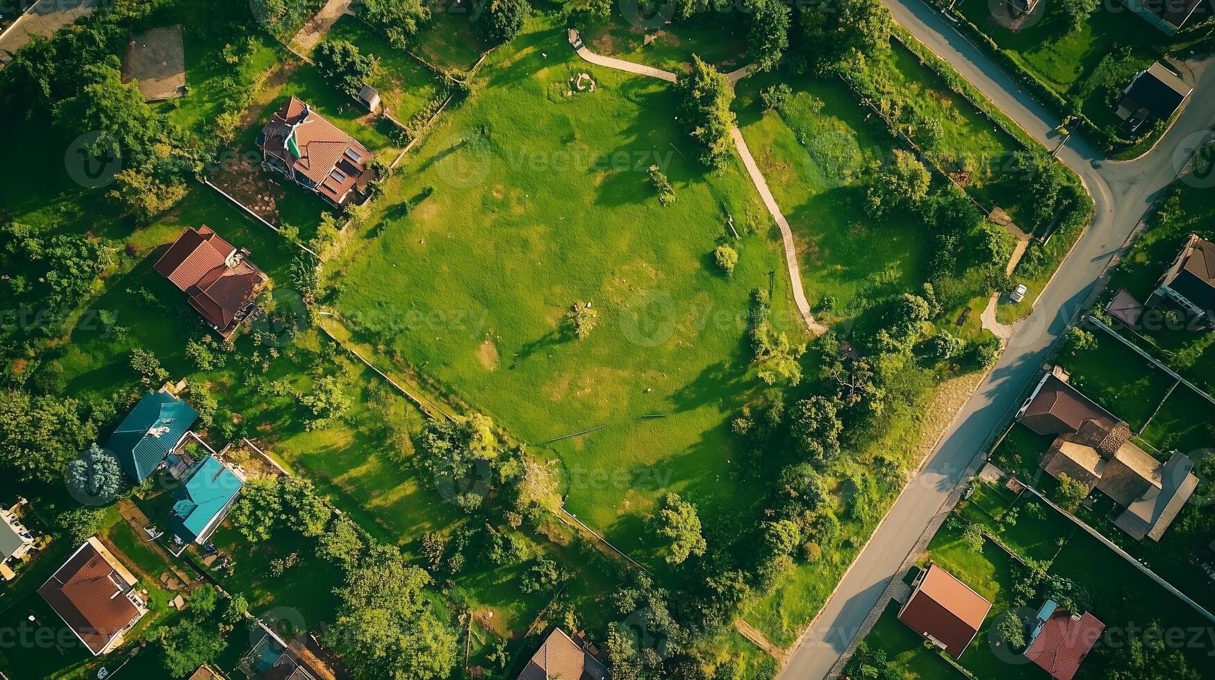 Aerial view of a lush green park surrounded by residential homes in a suburban neighborhood during daylight photo