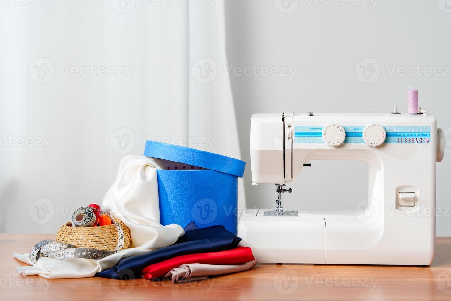A sewing machine with colorful threads and fabric in a bright crafting space for creative projects photo