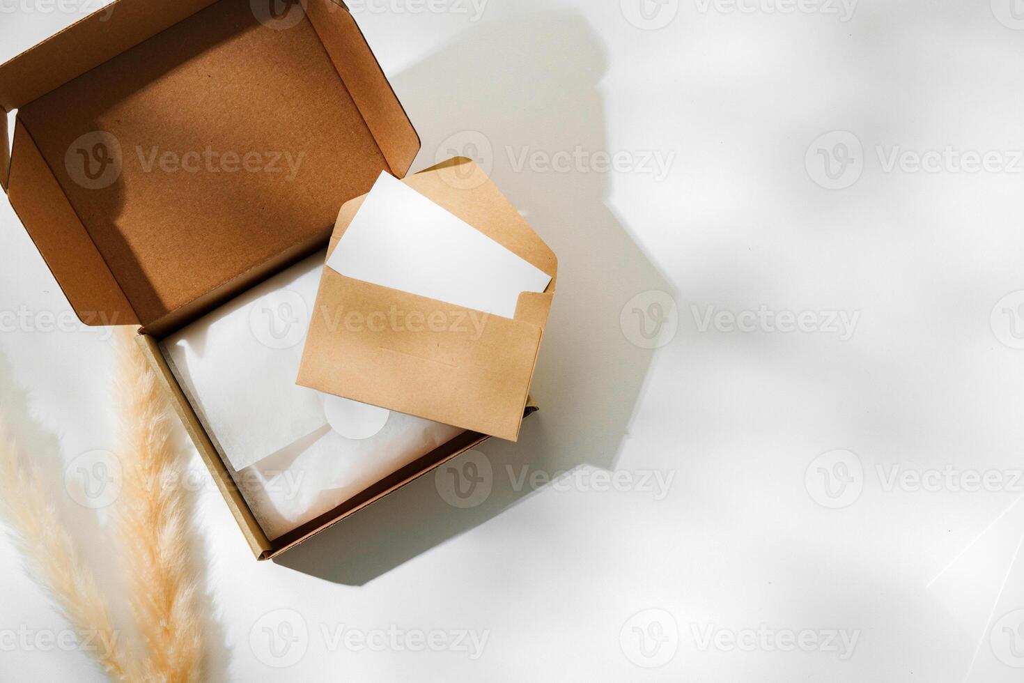 Delivery package with a blank envelope and decorative elements on a light background photo