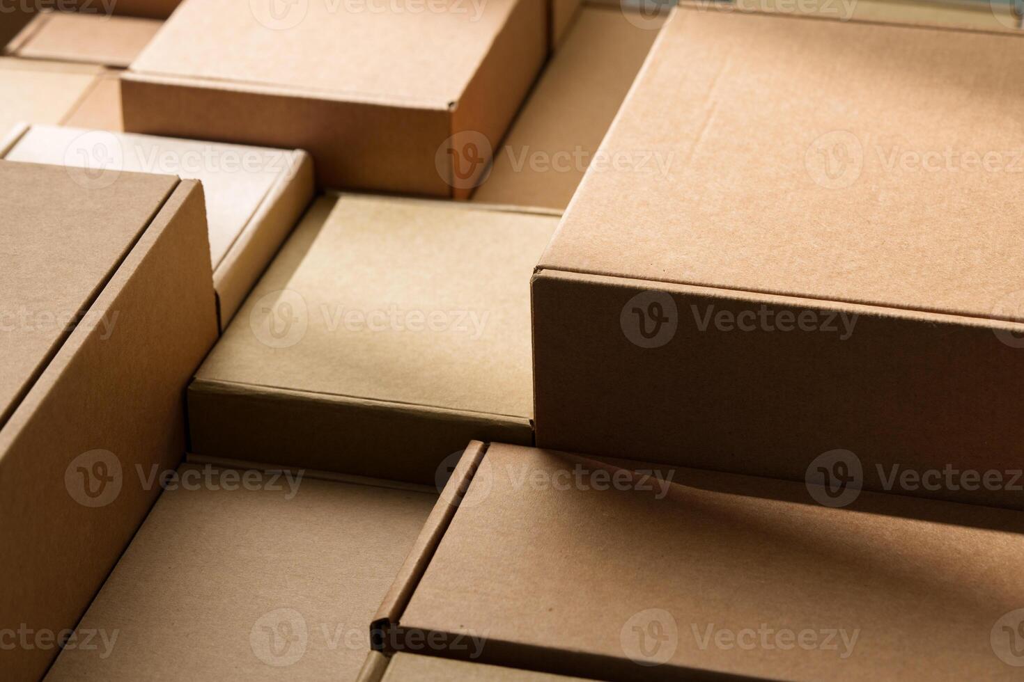Stacked cardboard boxes arranged in a neat pattern under natural light photo
