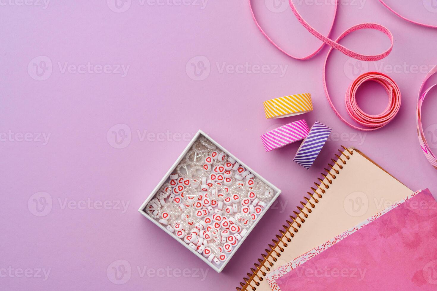 Crafting supplies on a purple background ready for creative projects photo