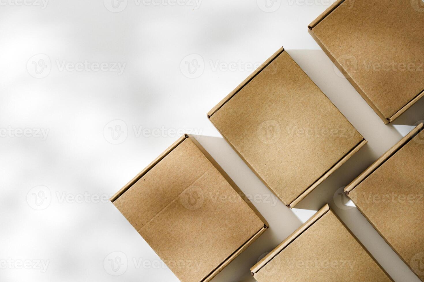 Brown cardboard boxes arranged on a neutral background in a warehouse setting during daylight hours photo