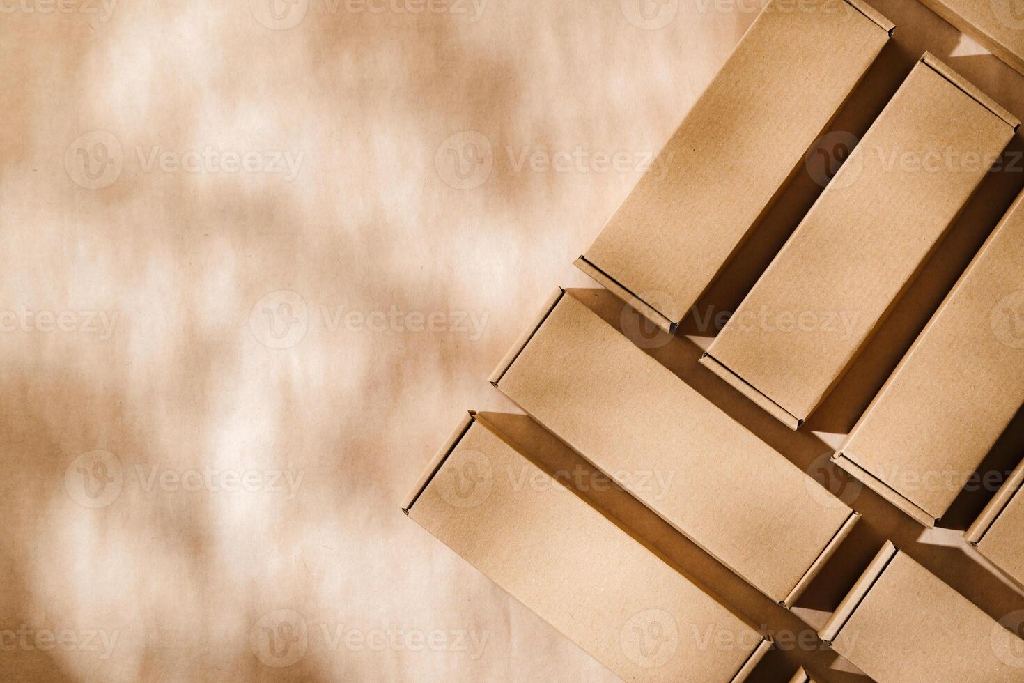 Brown cardboard boxes arranged on a neutral background in a warehouse setting during daylight hours photo