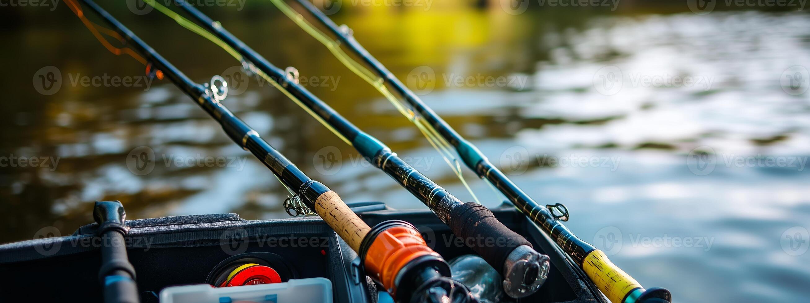 Fishing rods ready for action on the tranquil water during sunset at a peaceful lake photo