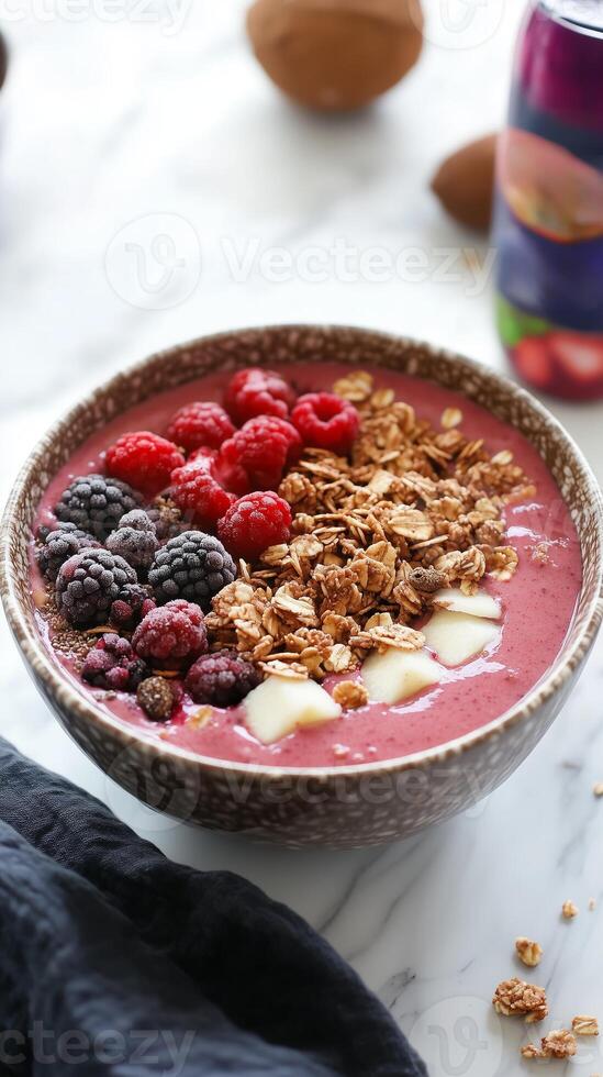 Delicious berry smoothie bowl topped with fresh fruits and granola, perfect for a healthy breakfast or snack photo