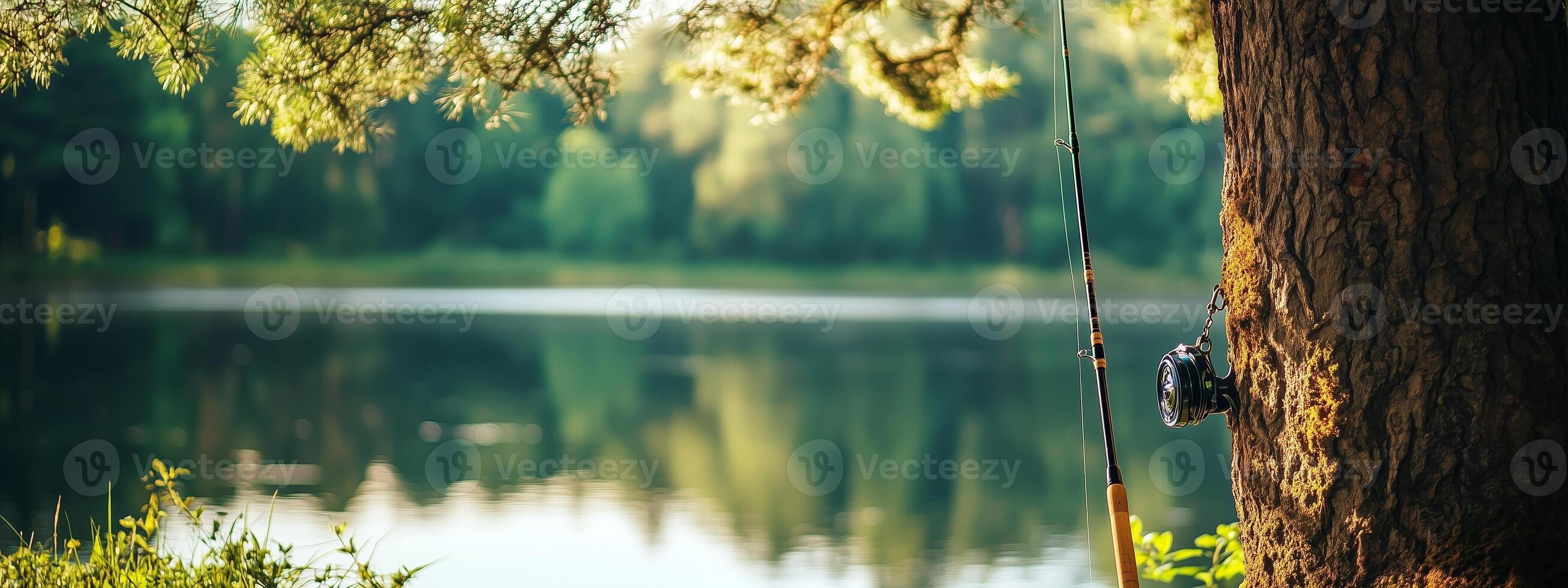 A serene fishing spot by a calm lake surrounded by trees on a sunny afternoon photo