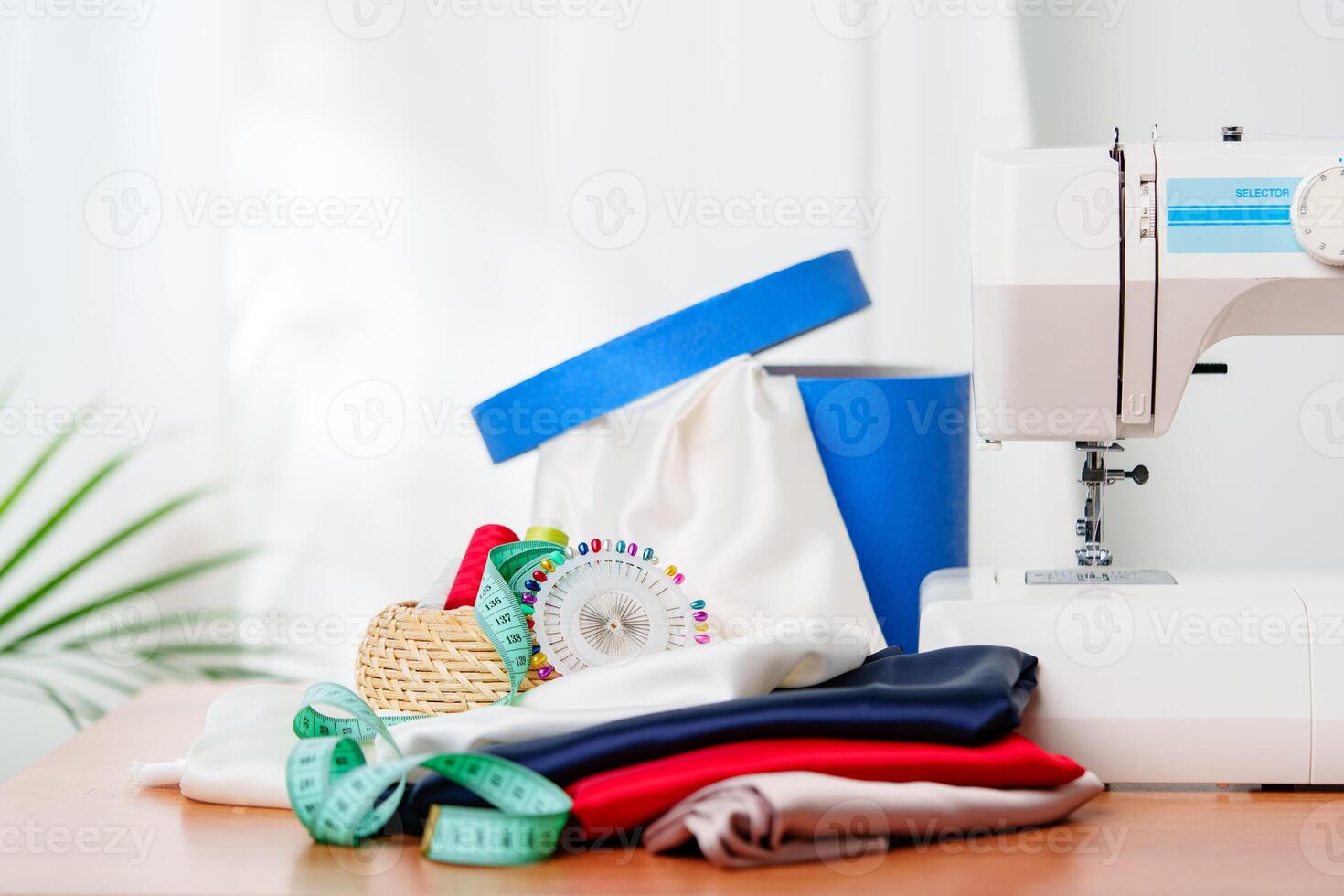 A sewing machine with colorful threads and fabric in a bright crafting space for creative projects photo