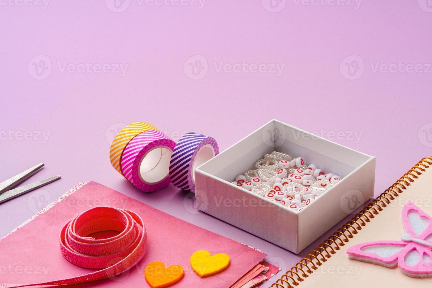Crafting supplies on a purple background ready for creative projects photo